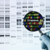 gloved hand holding a magnifying glass to view a DNA sequence that reveals a disease