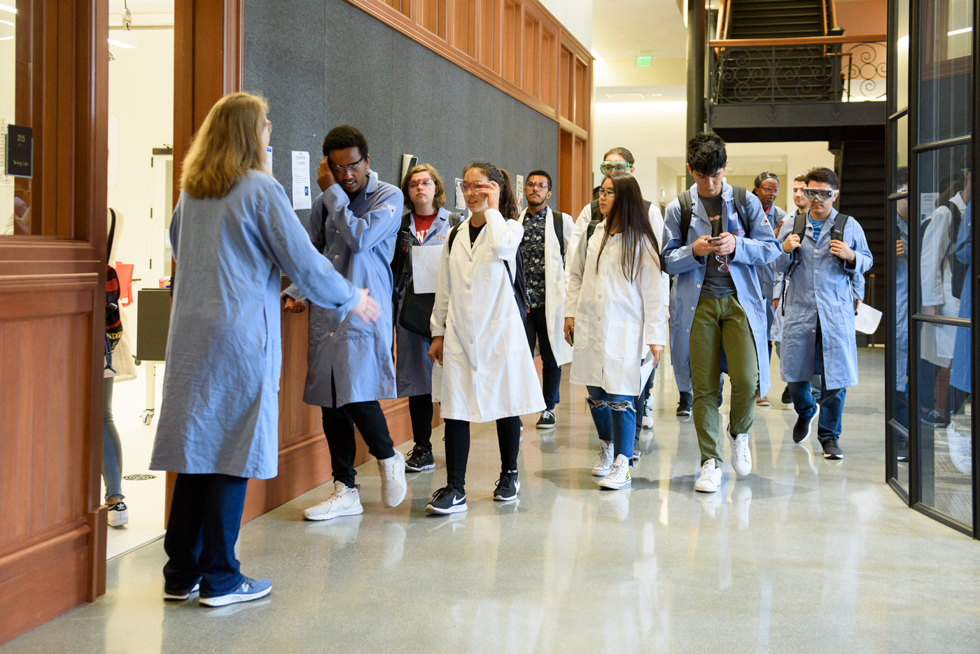 Jennifer Schwartz Poehlmann, senior lecturer in chemistry, left, welcomes the Leland Scholars to their first lab at Stanford.