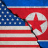 illustration of a cracked concrete wall with images of U.S. and North Korean flags