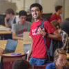 Graduate student Chiraag Sumanth stands among fellow students in the Huang Engineering Center.