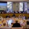 scholars at a Hoover Institution conference seated in a circular meeting room