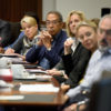 Several members of the Board of Trustees around a table.