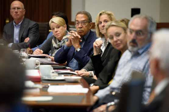 Several members of the Board of Trustees around a table.