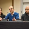 Stacey Bent, Ramesh Johari and Bryan Brown seated at a table. Johari speaking