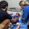 A Red Cross nurse from Sweden applies a dressing to a 3-year-old boy who was injured after an improvised explosive device detonated near him in Mosul, Iraq, on April 17, 2017.