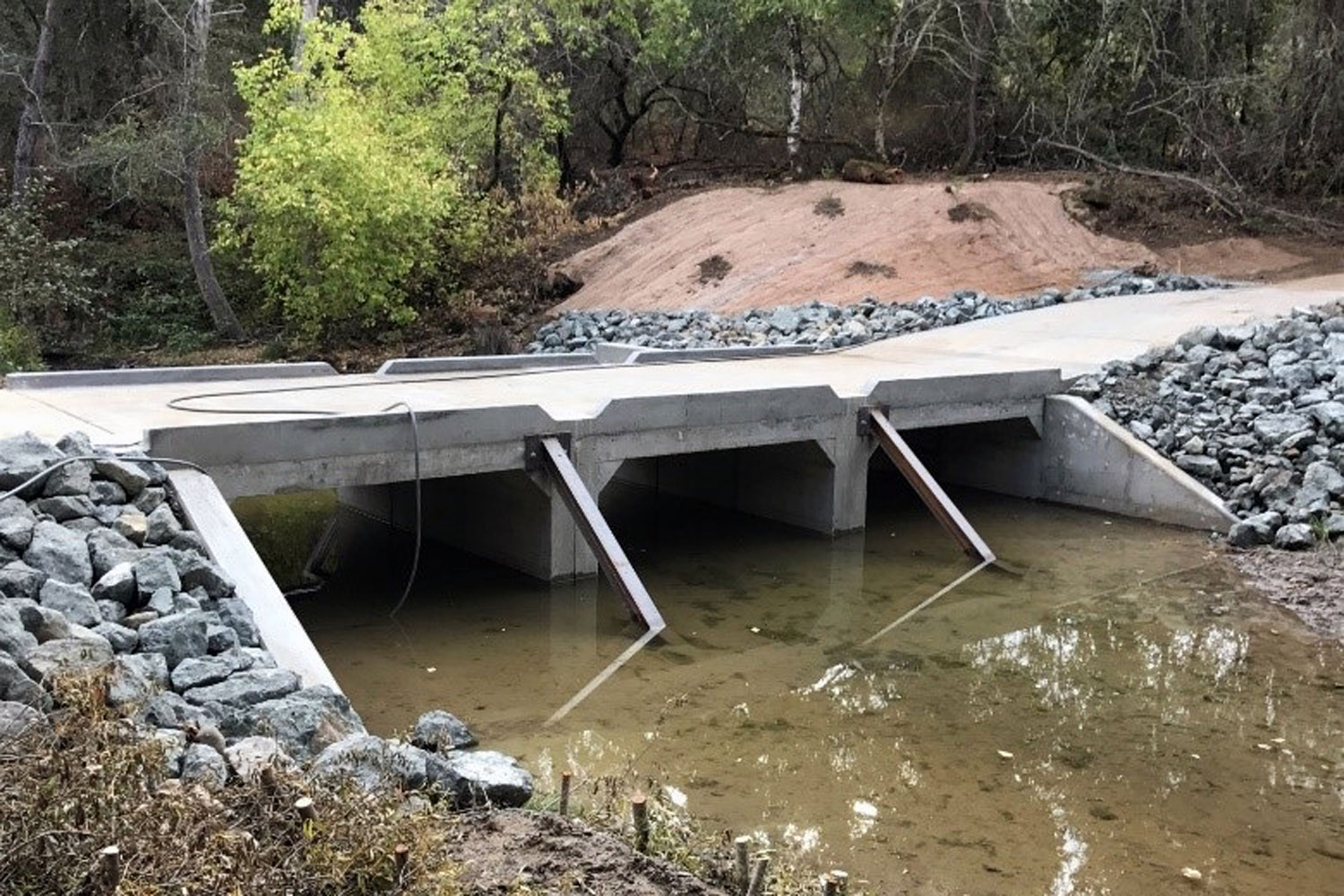 Roadway supported by box culverts that restored low flow and uninterrupted fish passage