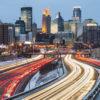 Heavy traffic flowing in and out of Minneapolis on Interstate 94 just after sunset, on a winter evening.