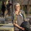 Alison Marson standing with her coat and bag