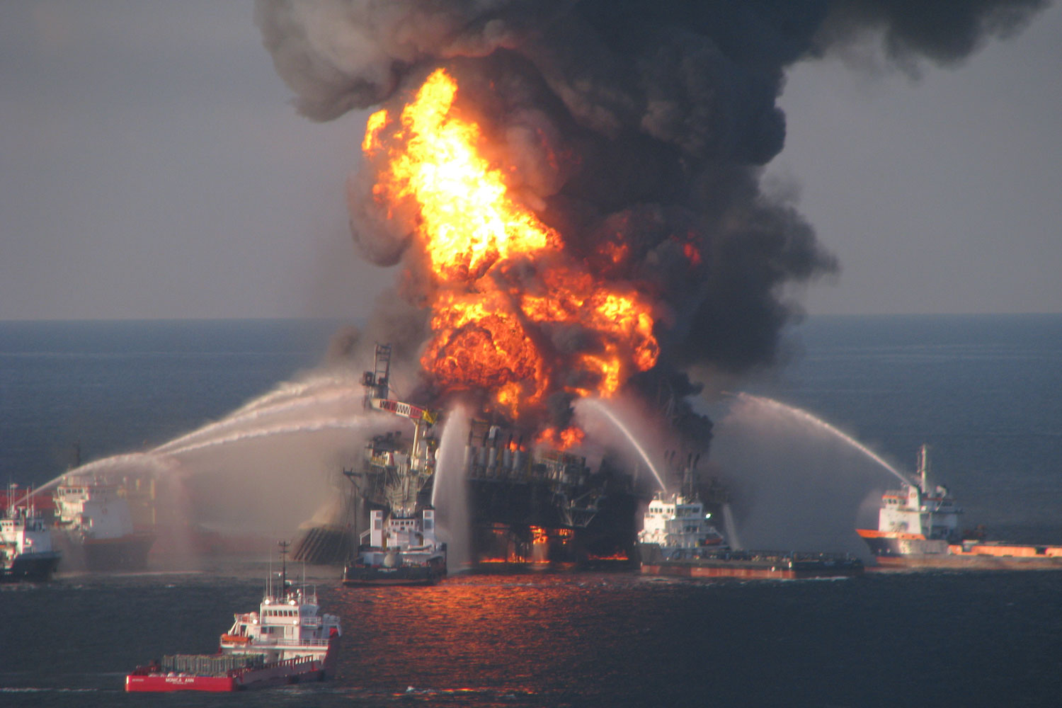 Fire boats and rescue crews respond to the 2010 Deepwater Horizon oil platform disaster in the Gulf of Mexico, the largest marine oil spill in history.