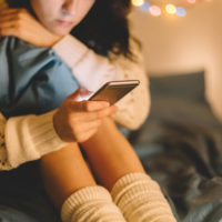 woman at home absorbed in her cell phone