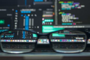 Looking through eyeglasses at a computer screen.