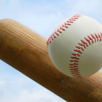 closeup of baseball and end of bat