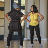 Dance lecturer Aleta Hayes, left, coaches a student in her presentation.