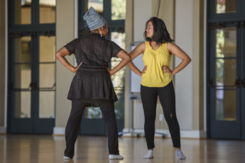 Dance lecturer Aleta Hayes, left, coaches a student in her presentation.