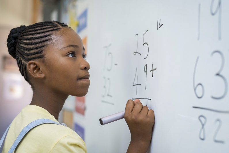 Girl solving math problem