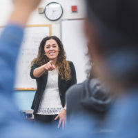 teacher calling on student with raised hand