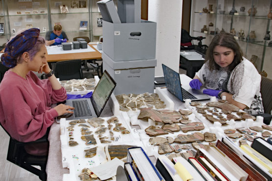 Students working in archaeology center