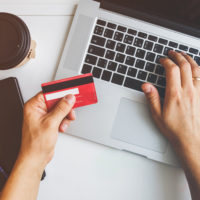 Top view of man using credit card for online shopping