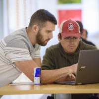 Garrett Gross, left, and Hugo Santos Parada, discuss an assignment