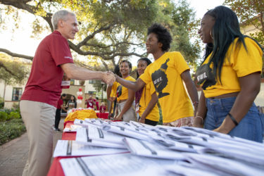 Stanford President Marc Tessier-Lavigne greets the staff of Ujamaa in Lagunita Court.