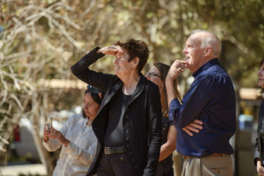 Ursula von Rydingsvard and John Hennessy watch the installation.