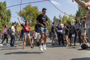 Drew Vallero jumps in the double-dutch ropes in White Plaza