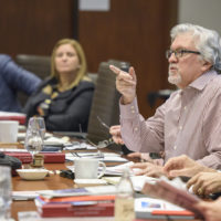 Jeff Raikes speaking at a table with others.