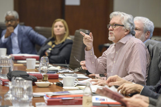 Jeff Raikes speaking at a table with others.