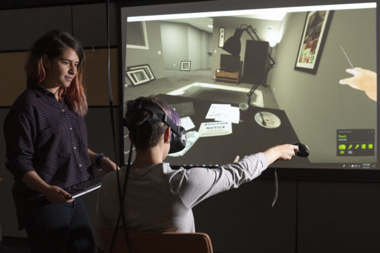 Fernanda Herrera, left, watches as fellow student Hannah Mieczkowski