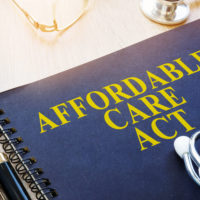 cover of a binder with words Affordable Care Act on the cover