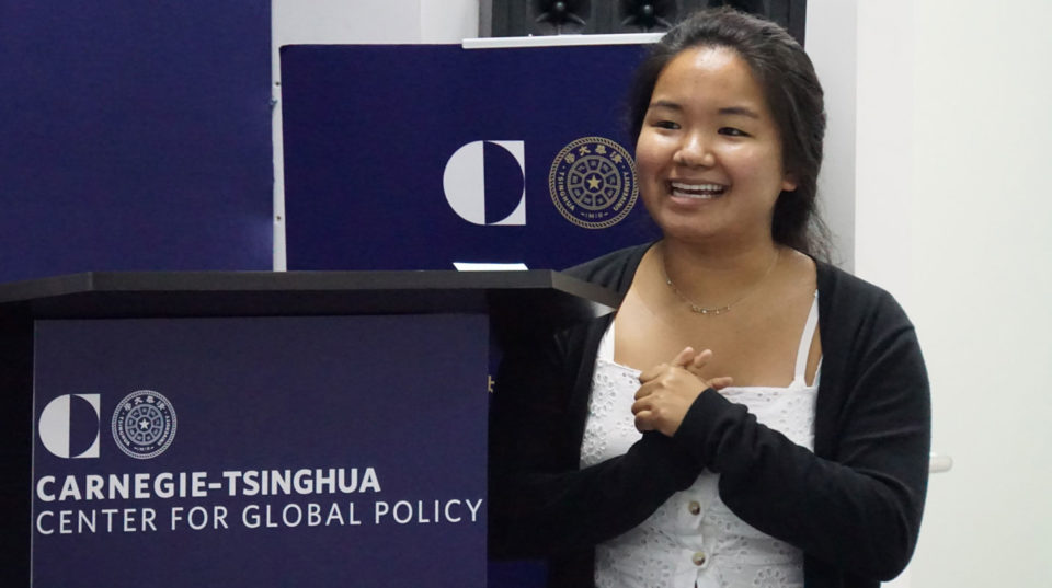 Yvonne Lee standing next to a lectern with Carnegie-Tsinghua Center logo