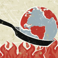 global warming illustrated by a globe being heated in a frying pan over flames