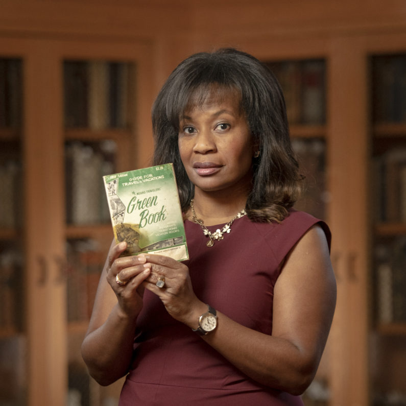 Allyson Hobbs with a copy of The Green Book from Stanford Libraries Special Collections