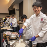 Kevin Guo, ’22, of Team Three prepares “ooo-baby pork chops” at the 16th annual Cardinal Cook-Off on Jan. 24 at the Arrillaga Family Dining Commons.