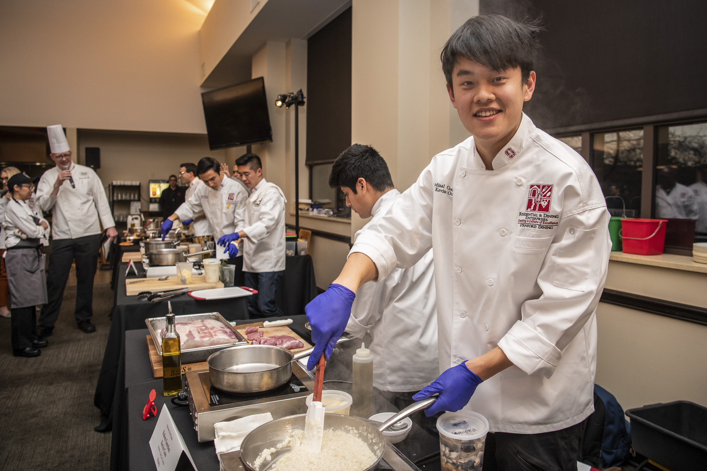 Kevin Guo, ’22, of Team Three prepares “ooo-baby pork chops” at the 16th annual Cardinal Cook-Off on Jan. 24 at the Arrillaga Family Dining Commons.