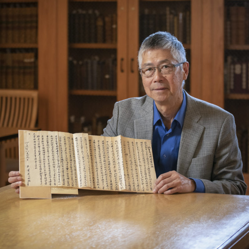 Gordon Chang with a letter from Ah Wing, reflecting on his longtime employment as the Stanford Family’s majordomo