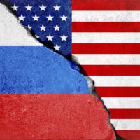 united states of america flag on broken damage wall and half russian white red blue color flag, relationship crisis between russia and usa concept