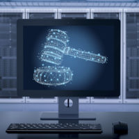 Internet law concept with 3D rendering on computer monitor displaying a judge's gavel