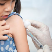 Young girl receiving a vaccination.