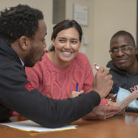 Stanford Graduate School of Business students, from left, Tawanda Mahere, Sarah Martin, and Andrew Matangaidze try to carry out their strategy during an exercise in their negotiations class.