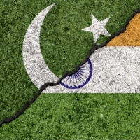 Flags of India and Pakistan painted on cracked wall background/India - Pakistan relations concept