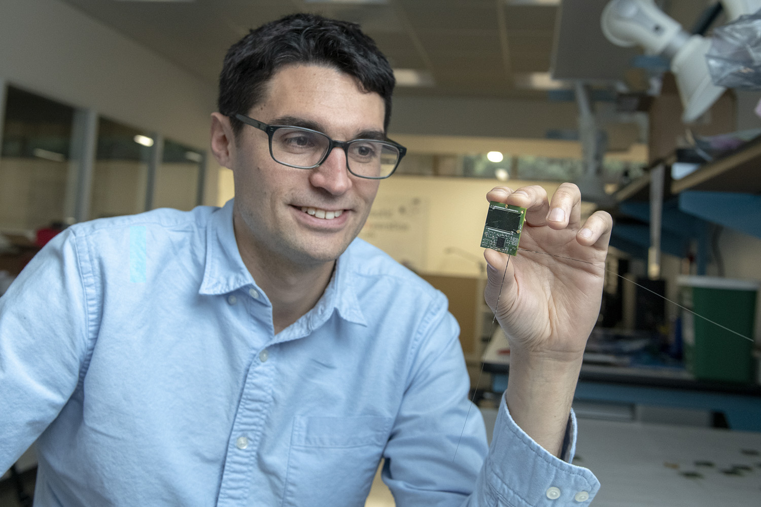 Zac Manchester holding the ChipSat device