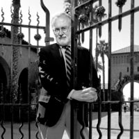 9/27/1996 Professor of English John L'Heureux at one of the iron gates in the Quad.