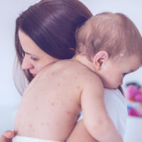 Mother nursing sick child At Home