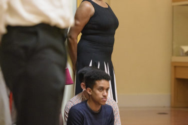 Aleta Hayes watches from the edge of the rotunda as Chocolate Heads perform