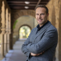 portrait of Jonathan Rodden in the arcades of the Stanford Quad