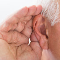 A hand cupping an ear