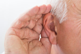 A hand cupping an ear