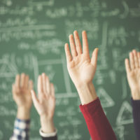 Students raising hands