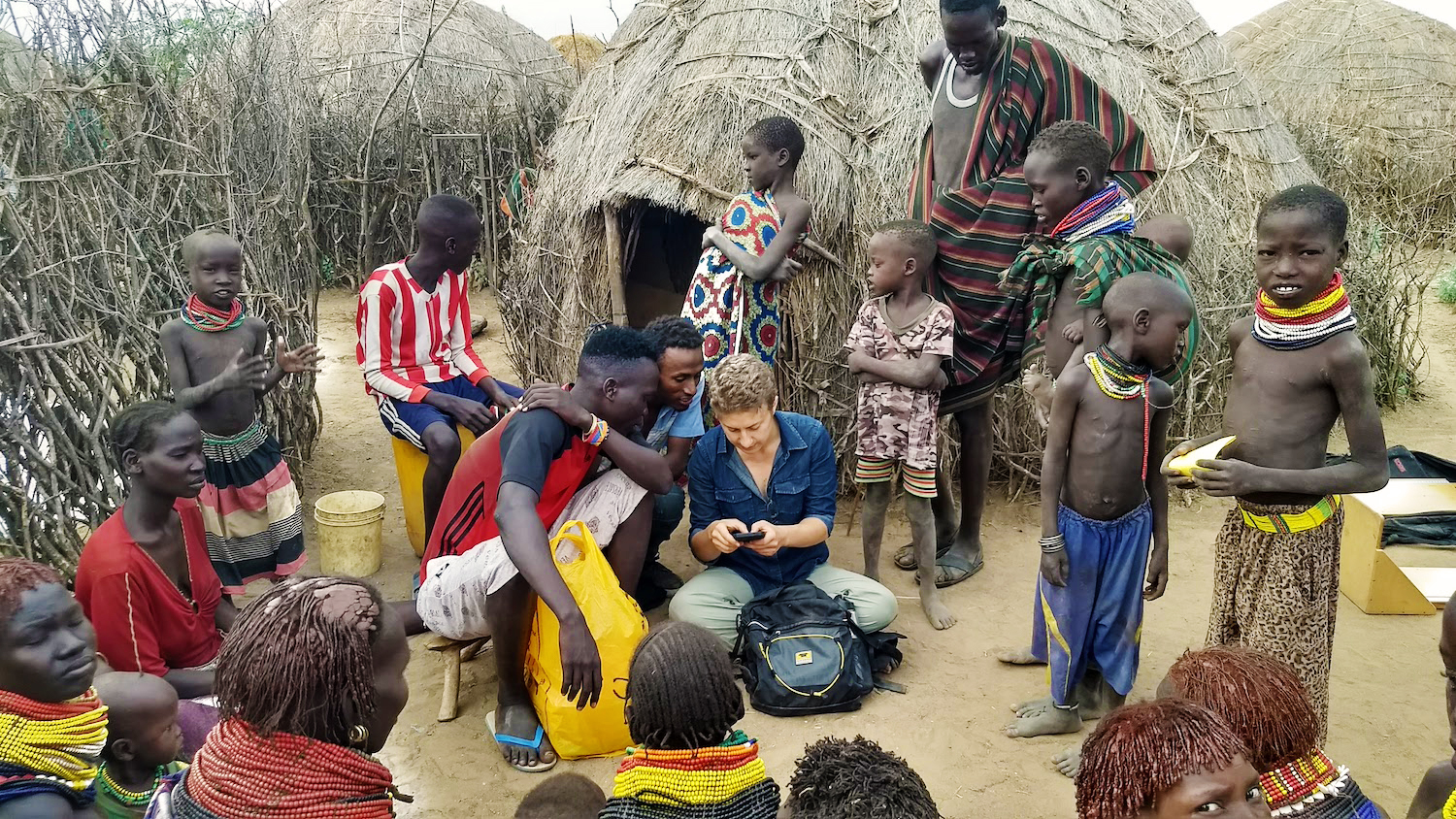 Woman in an Ethiopian village looking at a device